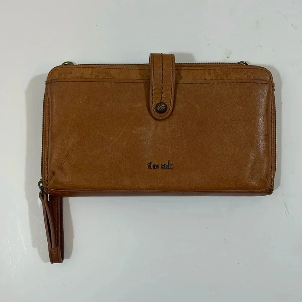 The sak brown leather‎ cell phone wristlet